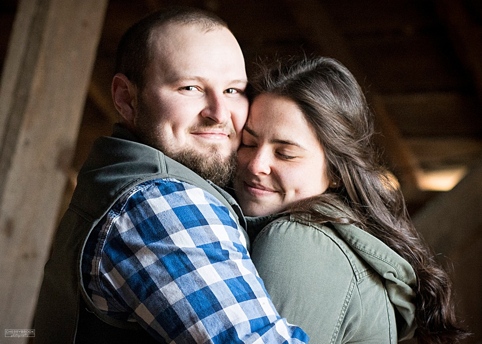 Engagement photographs captured in a barn with a country theme. 